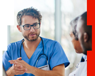 Oncologist in scrubs discussing precision medicine treatment options with a colleague