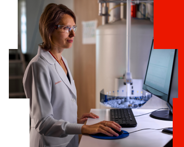 Lab technician operating NGS sequencing equipment to process biomarker test results