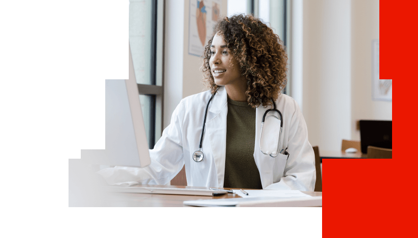 Physician using a computer to access biomarker testing and coverage resources